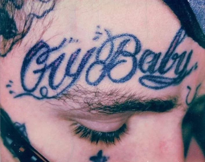 Lil Peep inspired Script 'Cry Baby' tattoo design for men on face.