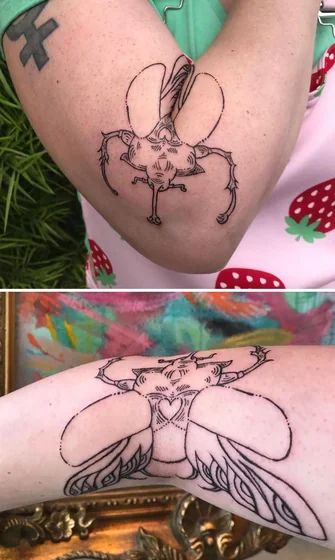 Linework beetle with heart tattoo for women on elbow