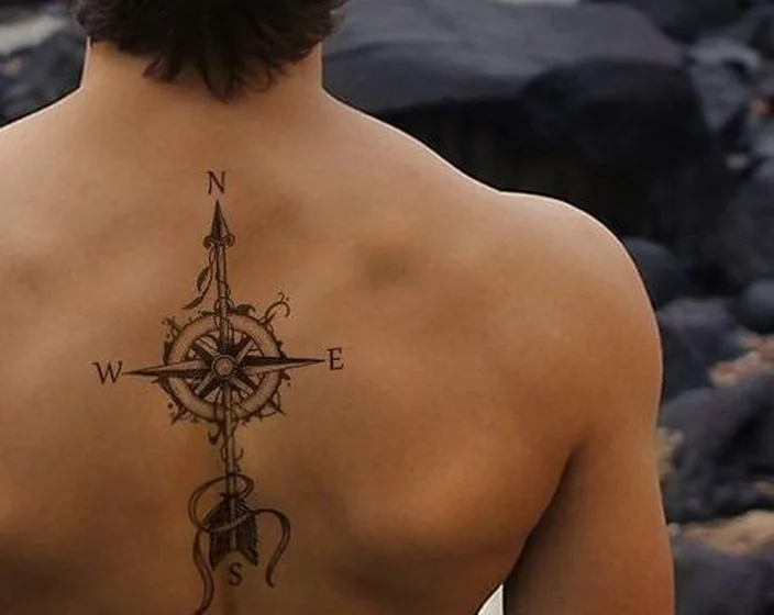 Linework compass and arrow tattoo design for men on back