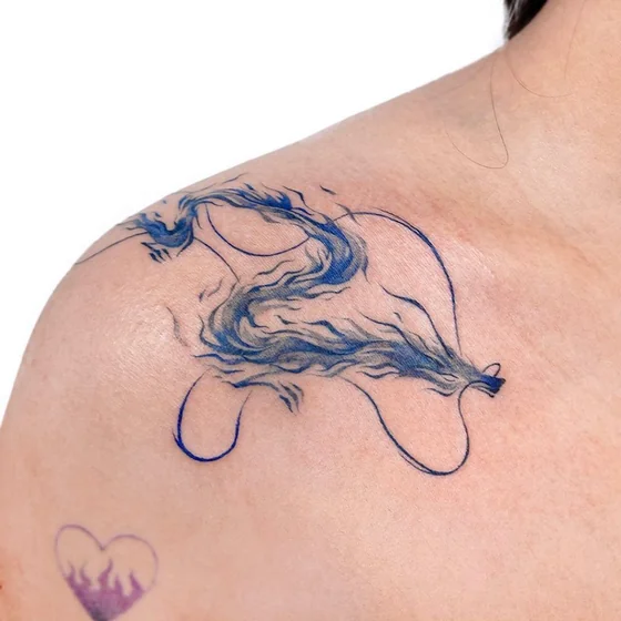Linework dragon and heart tattoo design for women on shoulder