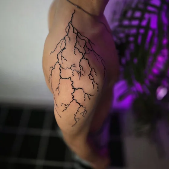 Linework lightning tattoo idea for men on upper arm