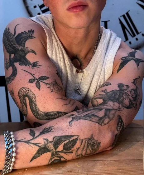 Masculine Patchwork Black And Grey arm tattoo idea: eagle, snake, rose, classical figure.