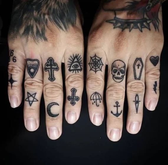 Men's Patchwork Blackwork finger tattoo idea: skull, cross, pentagram, coffin.