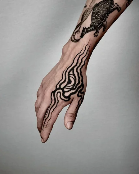 Men's patchwork blackwork dragon, turtle, abstract tattoo design on hand & forearm