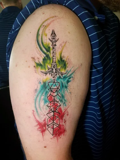 Men's watercolor sword & polyhedral dice tattoo on upper arm.