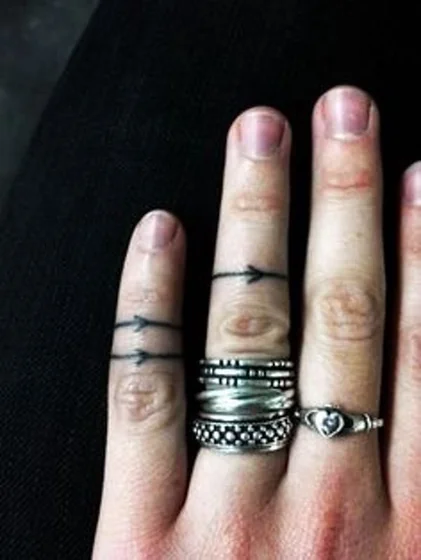 Minimalist Arrow and Ring tattoo design for women on Finger