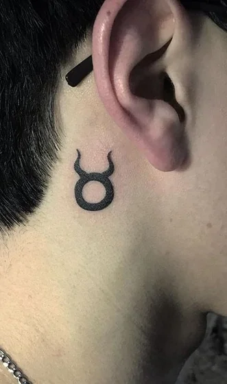 Minimalist Blackwork Taurus tattoo idea for men & women behind ear