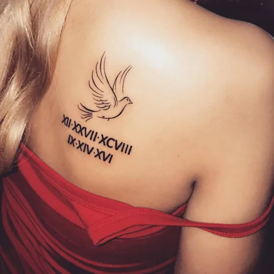 Minimalist Dove & Roman Numeral tattoo for ladies on shoulder