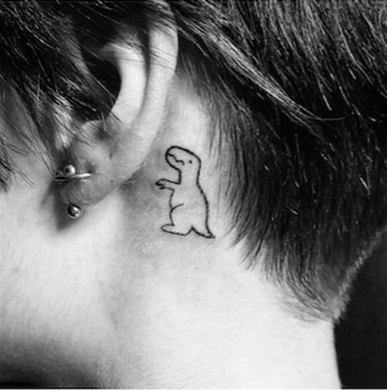 Minimalist Fine Line Dinosaur tattoo design for men and women behind the ear