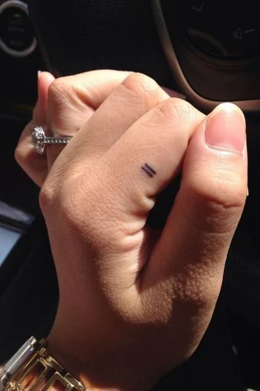 Minimalist Fine Line Equals Sign tattoo for women on Finger