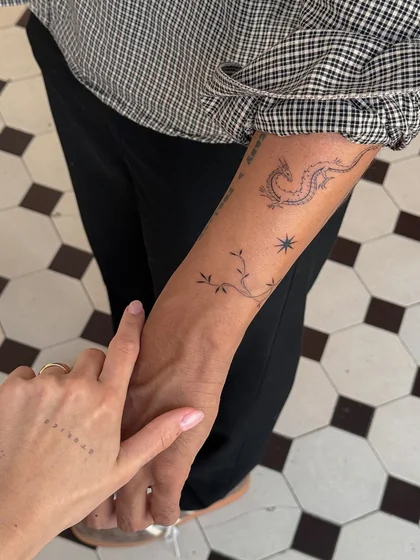 Minimalist Fine Line patchwork dragon, star, vine, and word tattoo ideas for women on forearm and hand.