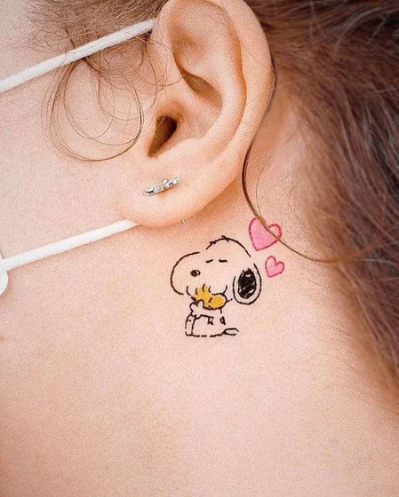 Minimalist Snoopy and heart tattoo design for women behind the ear