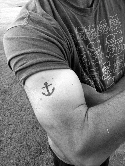 Minimalist anchor tattoo design for men on bicep