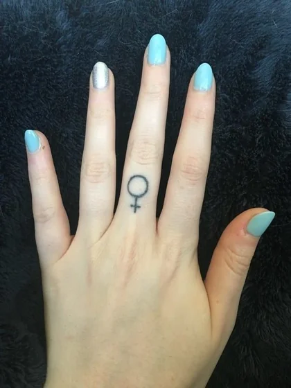 Minimalist female symbol fine line tattoo design for women on finger