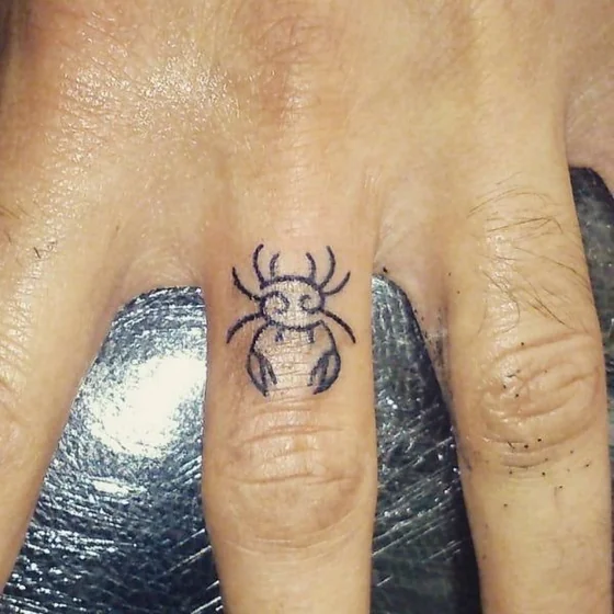 Minimalist fine line crab tattoo design for men on finger