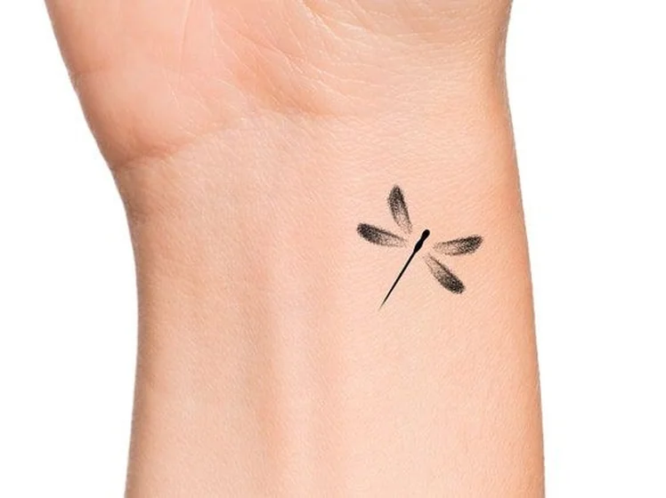 Minimalist fine line dragonfly tattoo idea for men and women on wrist tattoo ideas