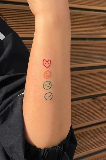 Minimalist fine line heart and emoticon tattoo for women on upper arm