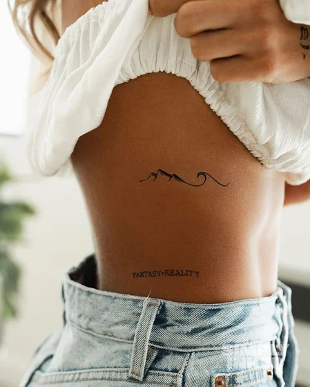 Minimalist fine line mountain, ocean, quote tattoo design for women.