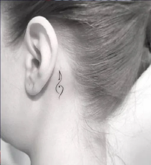 Minimalist fine line semicolon music tattoo for women behind ear