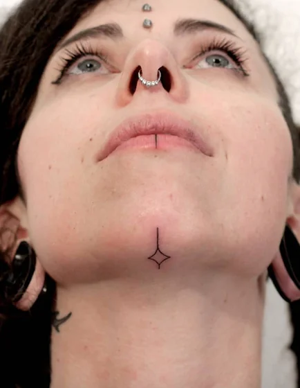 Minimalist fine line star tattoo design for women on face