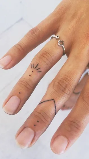 Minimalist fine line sun tattoo idea for women on fingers
