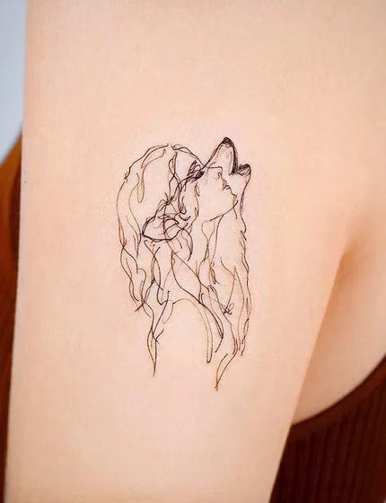 Minimalist fine line wolf tattoo design for women on upper arm