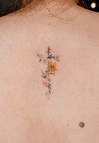Minimalist floral cross fine line tattoo design for women on back