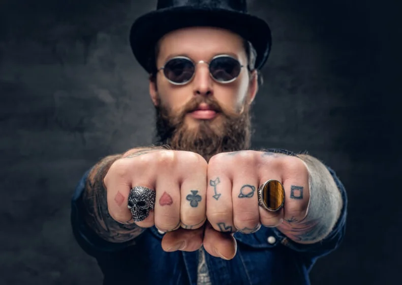 Minimalist linework playing card, arrow, planet tattoos for men on hands.