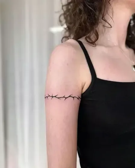 Minimalist thorny vine armband tattoo for women on upper arm