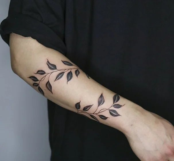 Minimalist vine floral tattoo idea for men and women on forearm