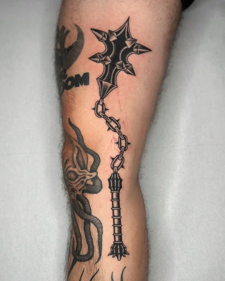 Neo-Traditional Black and Grey flail and horned creature tattoo for men on leg