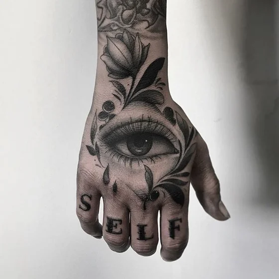 Neo-Traditional eye, flower, 'SELF' word tattoo idea for women on hand