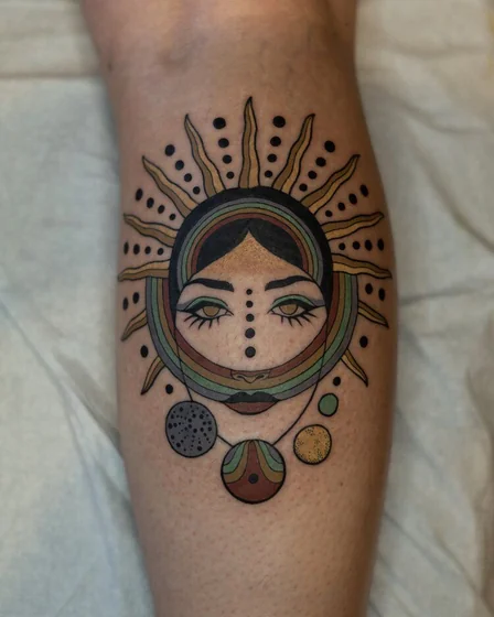 Neo-Traditional sun and galaxy tattoo idea for women on calf