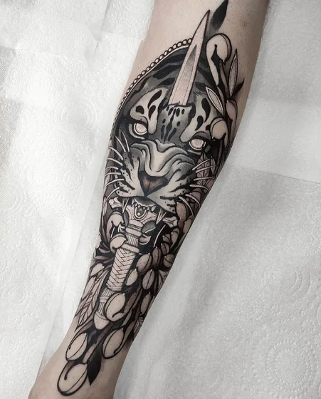 Neo-Traditional tiger dagger floral tattoo on forearm