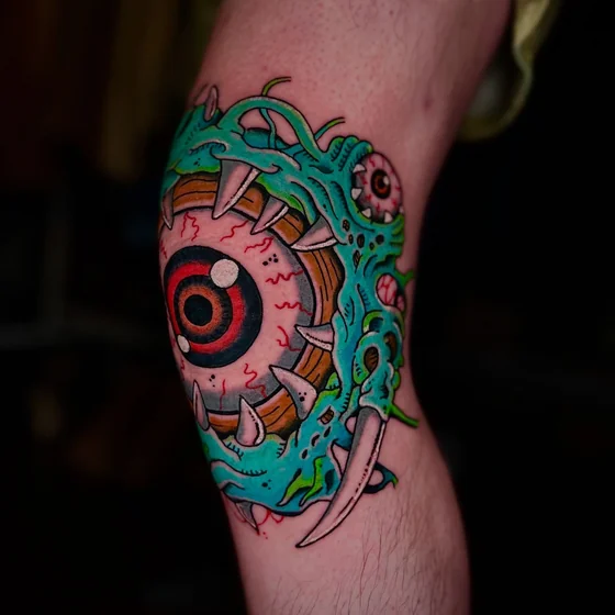 New School horror eyeball monster tattoo design for men on knee
