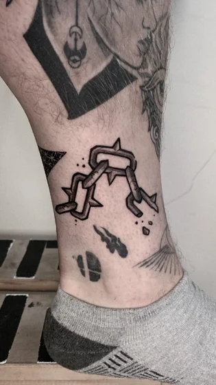 New School spiked chain patchwork tattoo design for men on ankle and calf