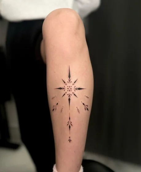 Ornamental Star Compass fine line tattoo idea for ladies on calf