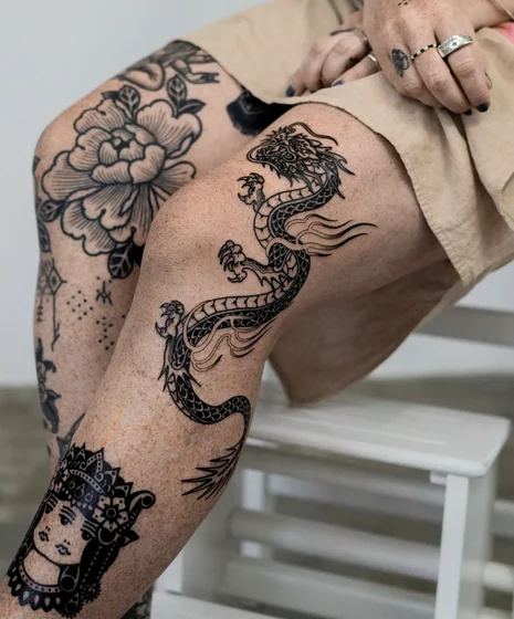 Patchwork Traditional dragon, flower, woman's face tattoo idea for women on thigh and knee