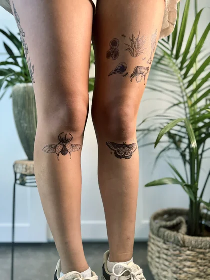 Patchwork engraving style beetle, moth, floral tattoo idea for women on thigh and knee.