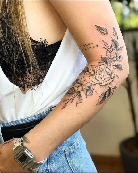 Patchwork linework rose floral tattoo design for women on upper arm