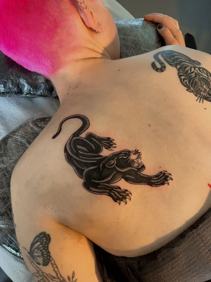 Patchwork traditional panther and tiger tattoo for women on back.