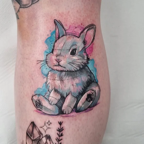 Patchwork watercolor rabbit tattoo idea for women on calf