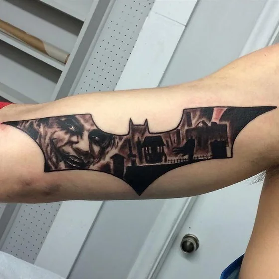 Realistic Batman and Joker tattoo design for men on bicep
