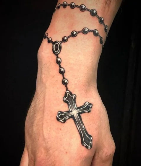 Realistic Black And Grey Cross tattoo design for men on wrist and hand