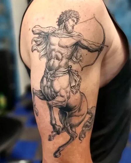 Realistic Black And Grey Sagittarius arrow tattoo design for men on upper arm