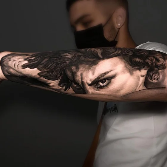 Realistic Black And Grey Saint Michael tattoo for men on forearm