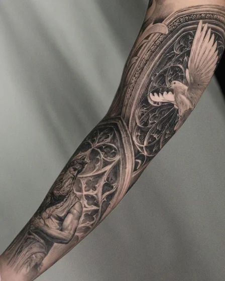 Realistic Black And Grey religious dove & saint tattoo design for men on forearm
