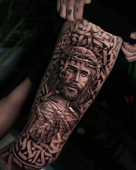 Realistic Jesus portrait with quote tattoo idea for men on upper arm