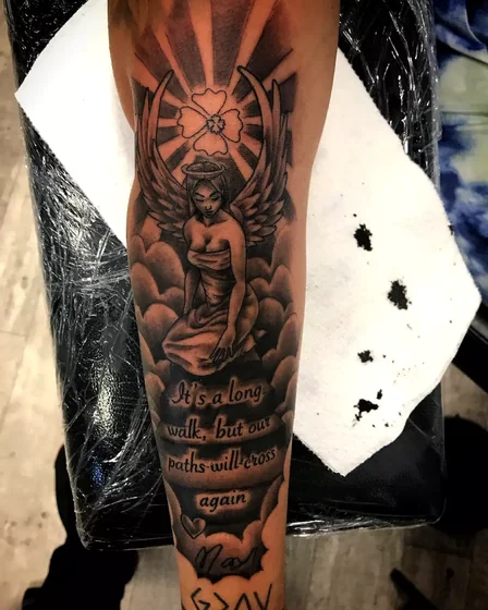 Realistic angel and quote tattoo idea on forearm for women