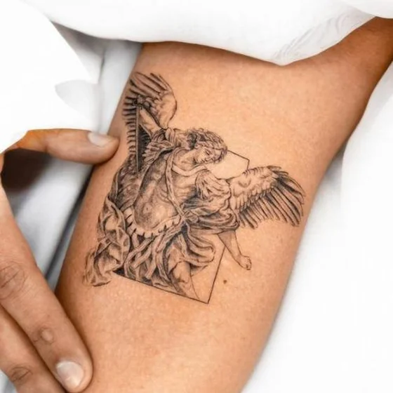 Realistic angel with wings tattoo design for women on upper arm